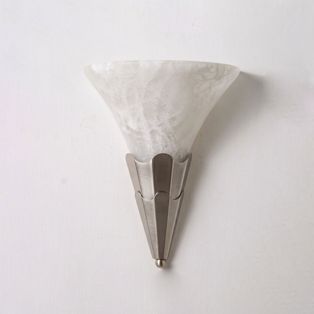 Studio shot on a bare backdrop, this Clérachic sconce's alabaster shade sits on a brushed nickel fluted base.