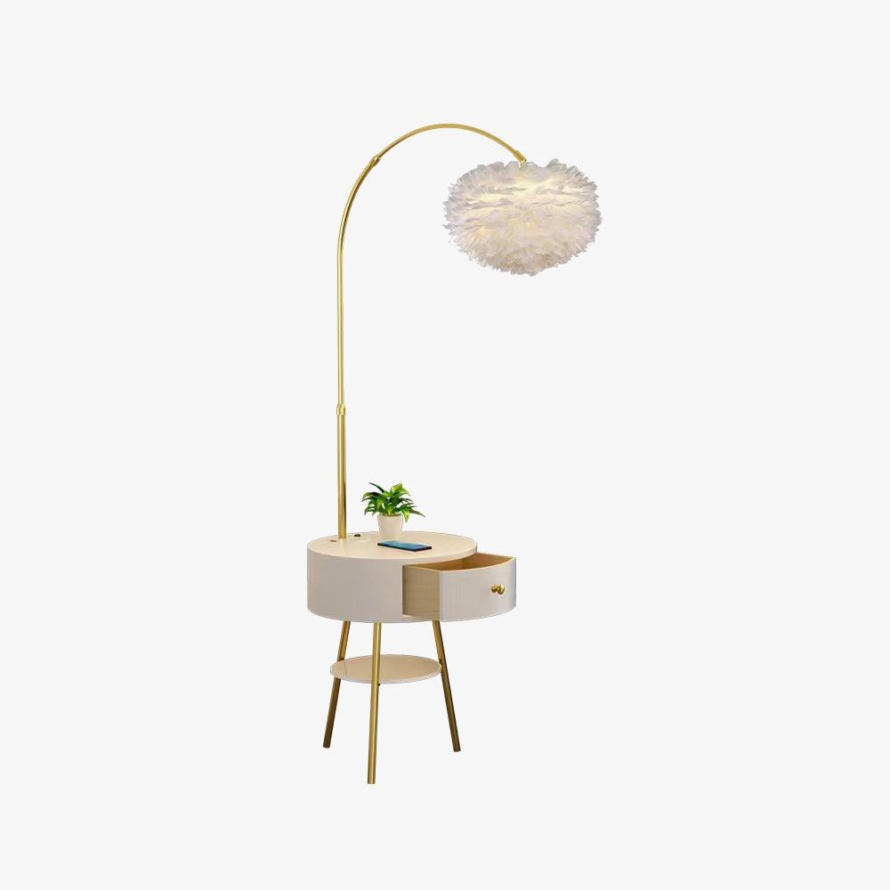 Clérachic gold arc floor lamp with a white feather pompom shade and built-in round marble table, photographed against a plain white background.