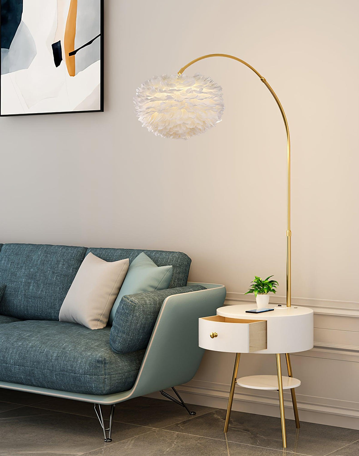 In a living room corner, this Clérachic gold arc lamp arches its feather shade over a teal sofa, the marble side table tucked beside it.