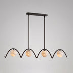 Against a plain grey backdrop, this Clérachic chandelier's four arched tubes and ball shades sit in matte black.