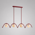 Seen alone on a plain backdrop, the four looping arches of this Clérachic chandelier show here in matte red.