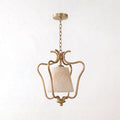 Cropped close on a plain background, this Clérachic pendant's brass cage curls around the base of its alabaster shade.