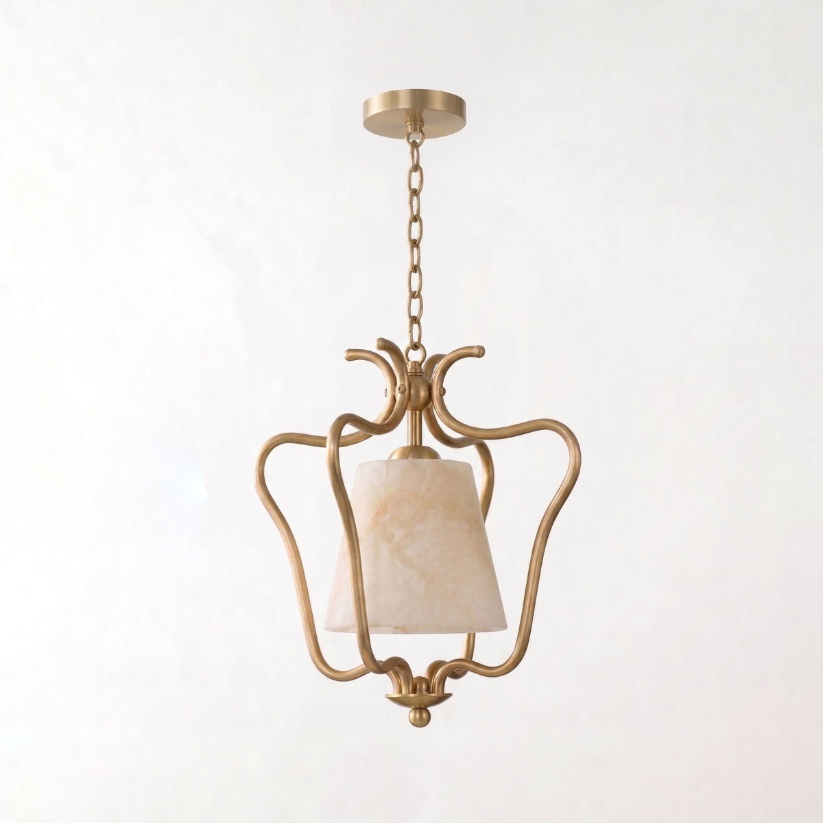 Cropped close on a plain background, this Clérachic pendant's brass cage curls around the base of its alabaster shade.