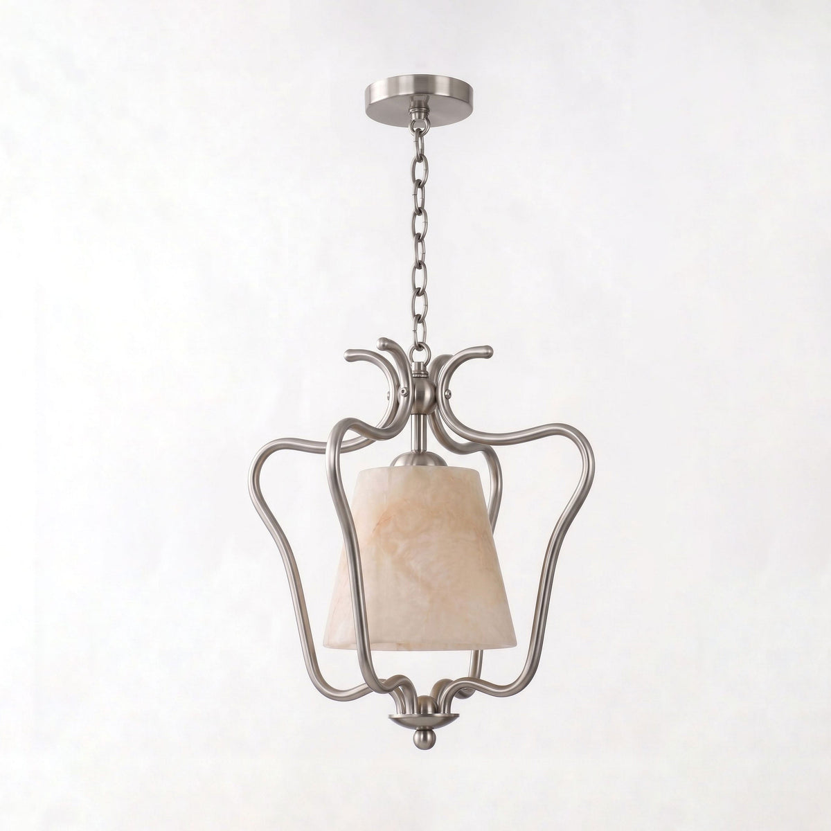Shown unlit on white, the nickel finish of this Clérachic pendant forms hand-scrolled arms around its alabaster shade.