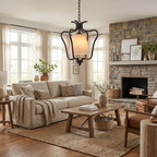 Beside a stone fireplace in a living room with a beige sofa, this Clérachic pendant's black finish glows warmly overhead.