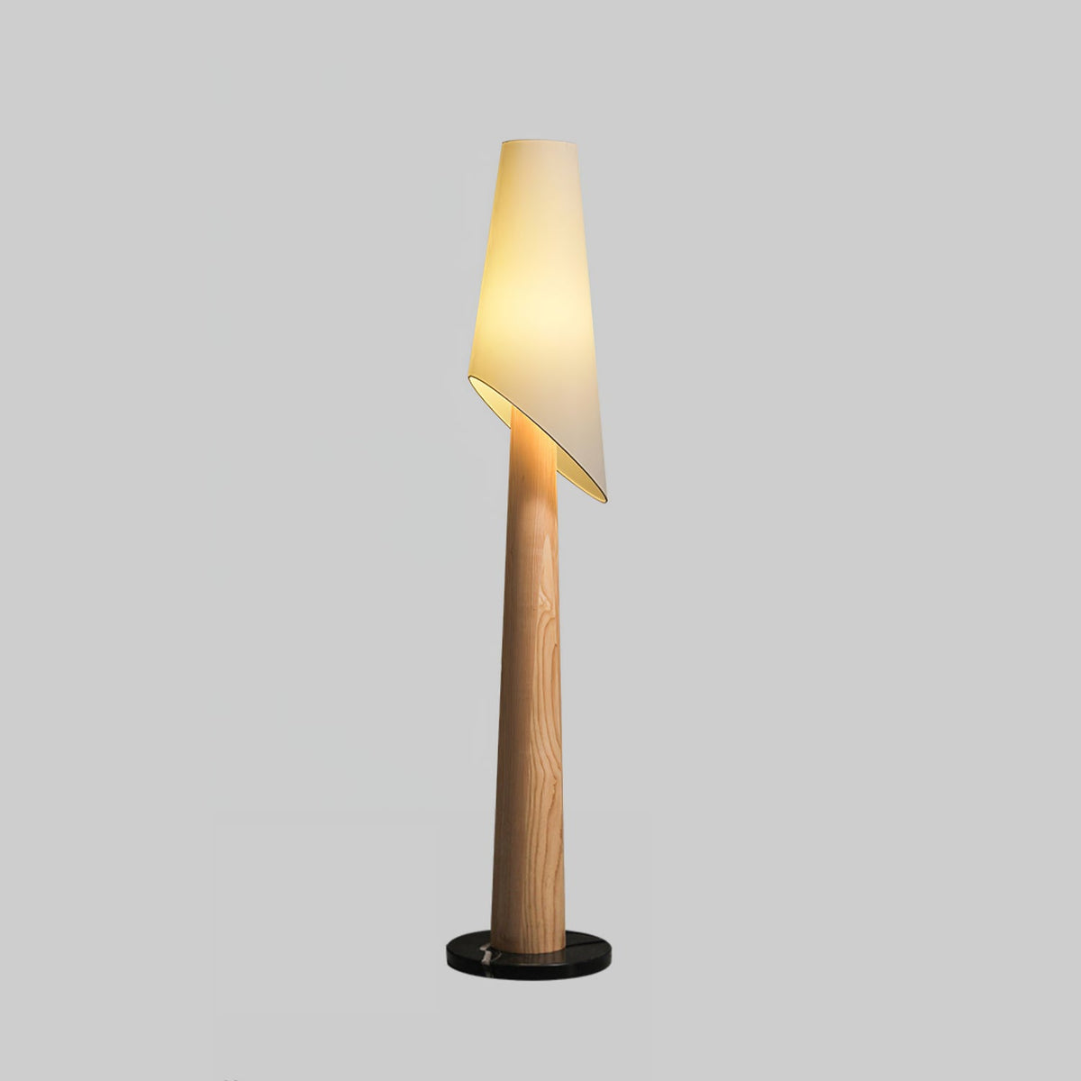 A lighter wood-toned Clérachic floor lamp stands lit against a plain grey studio background.