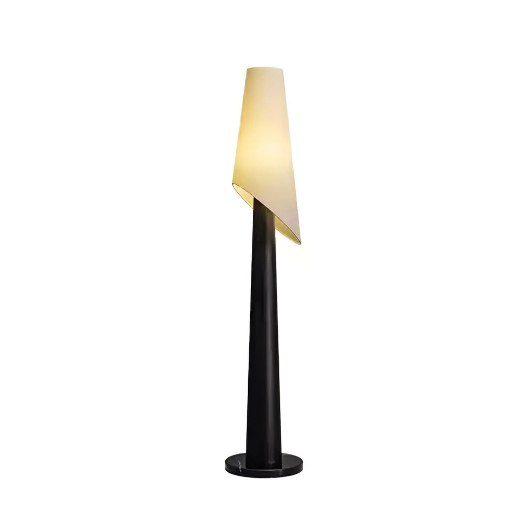 A black-bodied Clérachic floor lamp stands lit against a plain white studio background, its angled shade tilted.