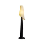 A black-bodied Clérachic floor lamp stands lit against a plain white studio background, its angled shade tilted.