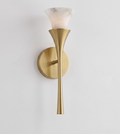 Lit on a bare white backdrop, this Clérachic sconce's alabaster shade glows above a brushed brass trumpet stem.