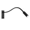 Gooseneck wall lamp with flexible arm mounted beside a reading nook