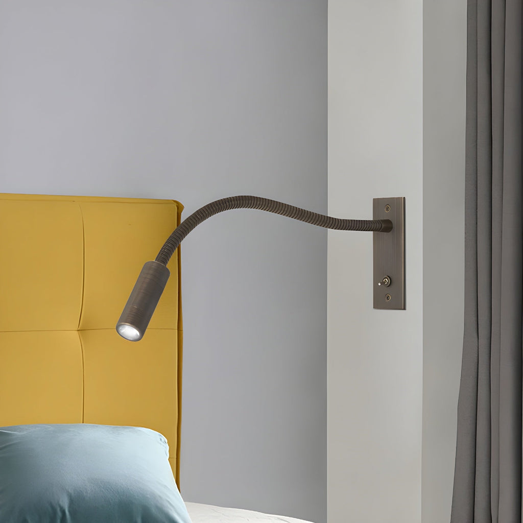Brushed bronze gooseneck wall lamp aimed for bedside reading