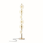 Photographed alone on white, this Clérachic floor lamp shows its full run of tiered acrylic discs and trailing cord.