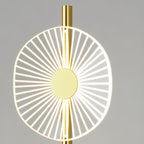 A macro shot isolates one Clérachic floor lamp disc, its fine radiating lines glowing around a solid gold centre pin.