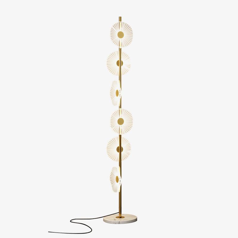 A second studio view of this Clérachic floor lamp against a plain grey backdrop, its acrylic discs lit along the gold pole.