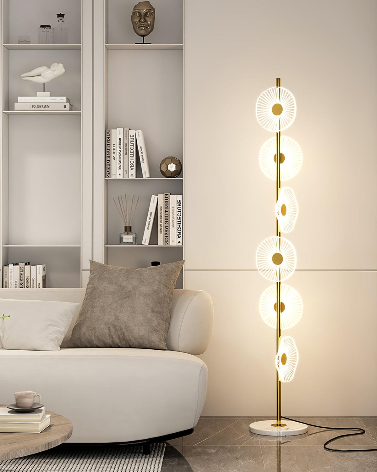 Beside a curved white sofa and a round marble side table, this Clérachic floor lamp's discs glow against a polished floor.