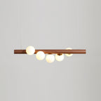 Linear wood pendant light with walnut bar and opal glass globes