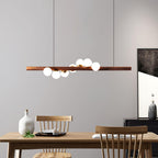 Walnut pendant light detail showing glass globe and grain
