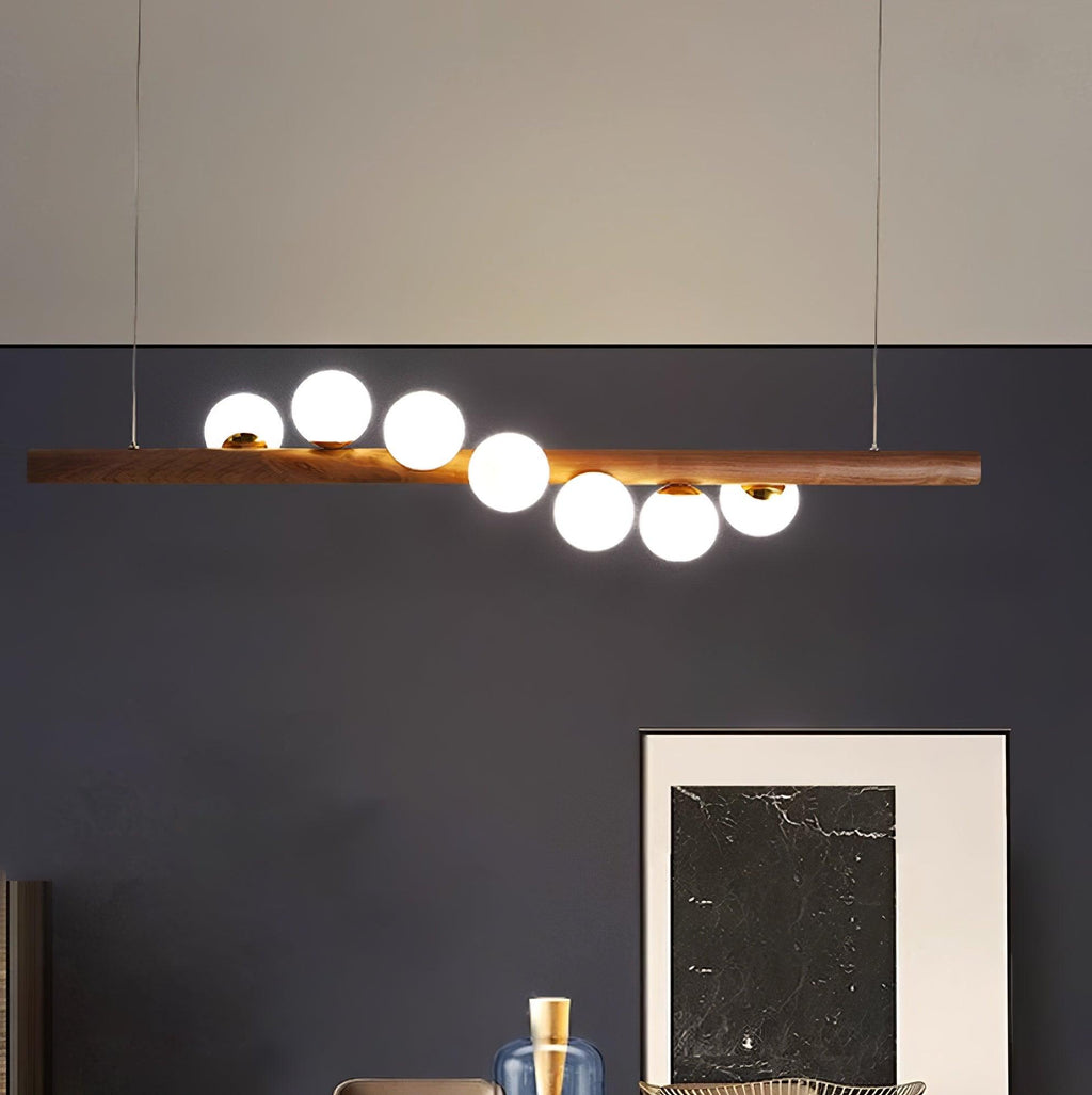 Walnut and opal glass pendant light glowing in a warm interior