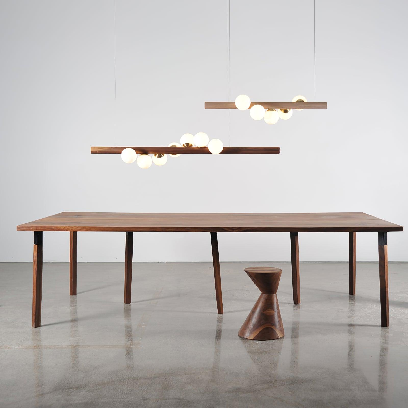 Close detail of opal glass globe and warm walnut wood grain
