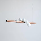 Linear walnut pendant adding warmth to an open plan space