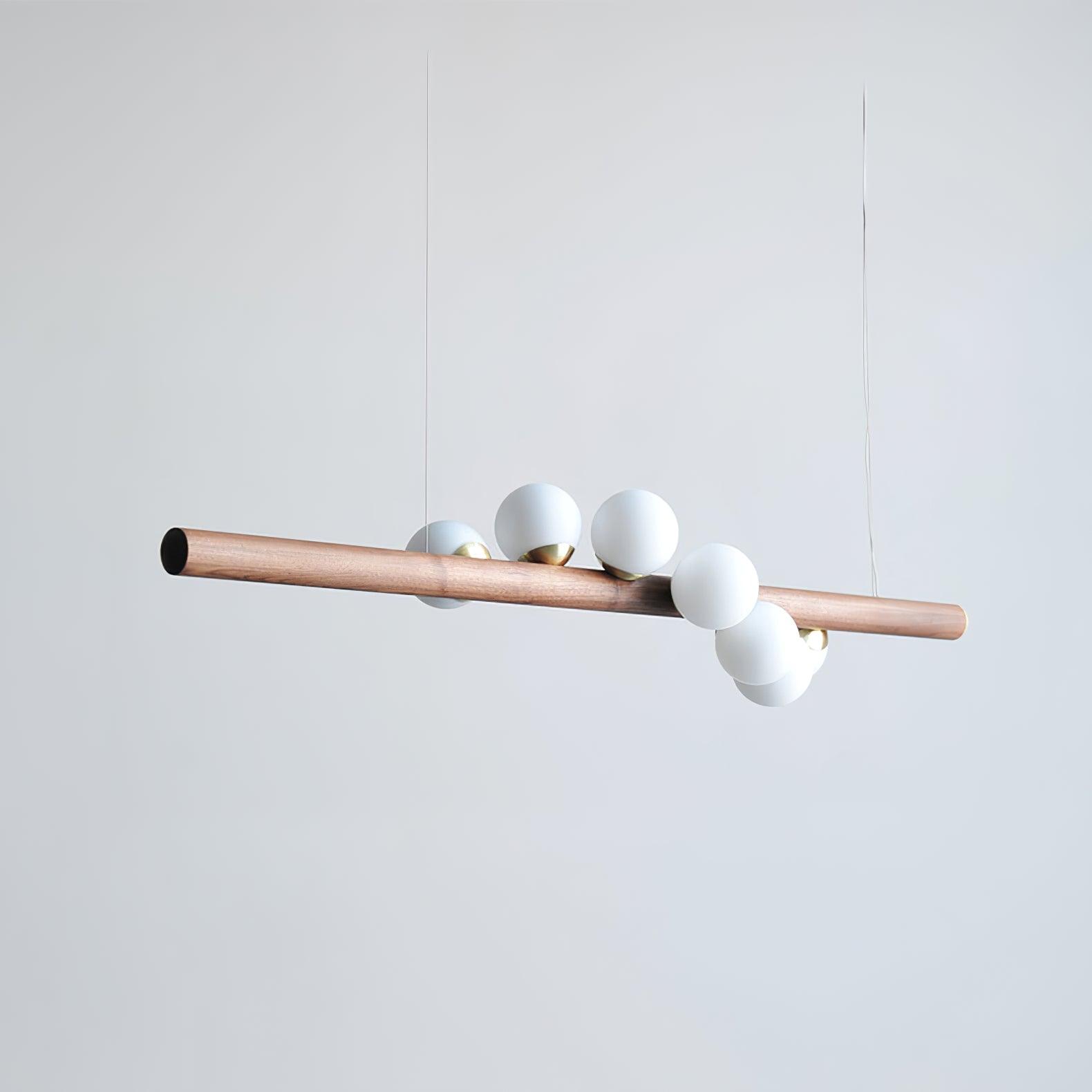 Linear walnut pendant adding warmth to an open plan space