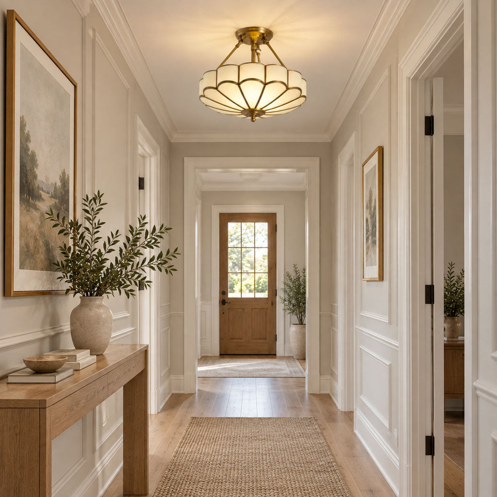 At the end of a hallway with a console table and olive branches, this Clérachic ceiling light glows near the front door.