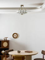In the same room with a travertine table and wall mirror, this Clérachic ceiling light glows near the crown moulding.