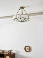 In a plain room with a small wall clock and a wooden cabinet, this Clérachic ceiling light glows close to the ceiling.