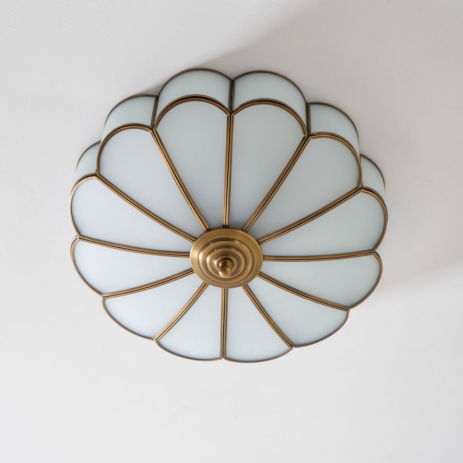 Frosted glass petal ceiling light detail with brass frame