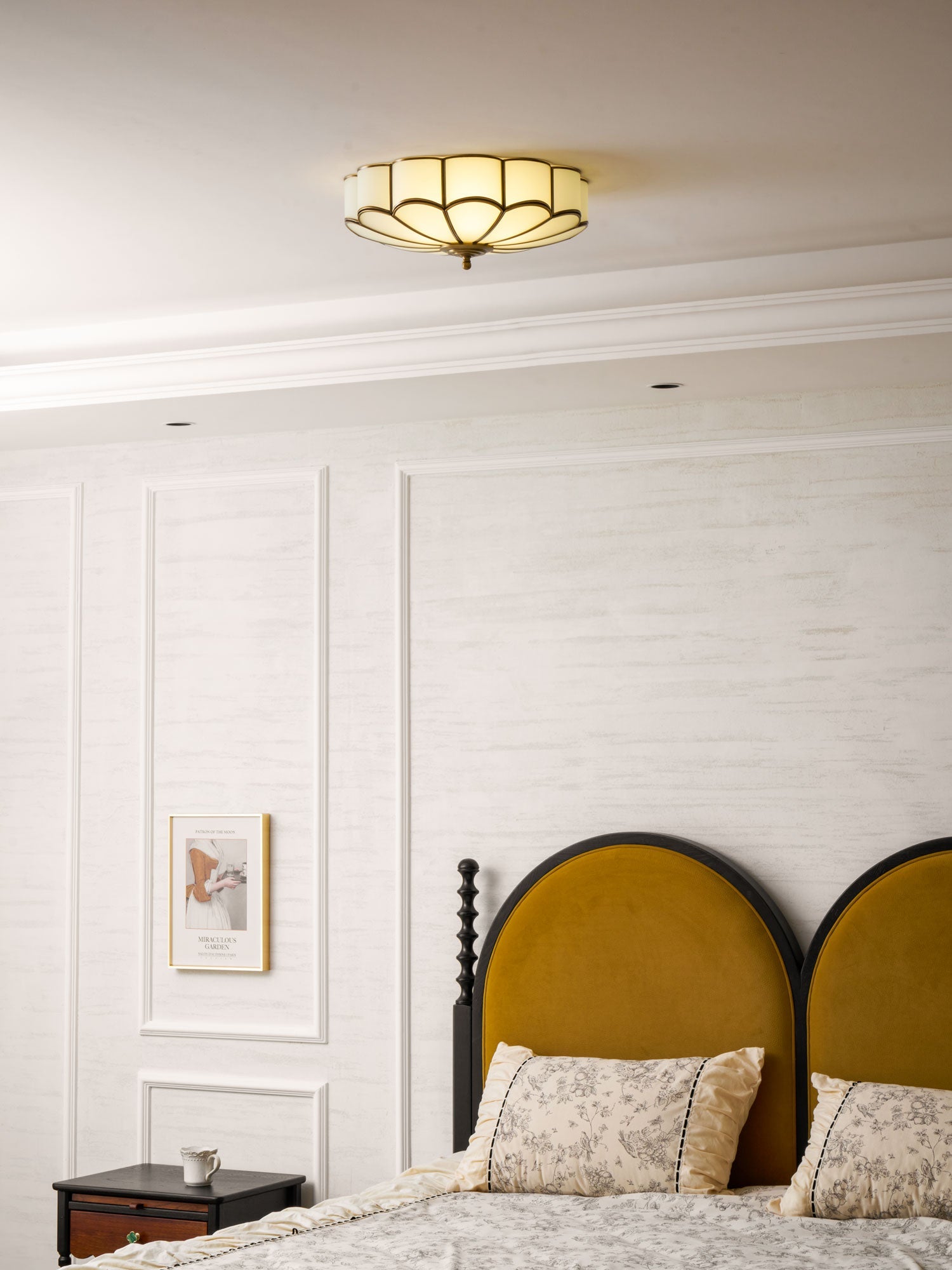 Brass flower ceiling light glowing gently in an interior