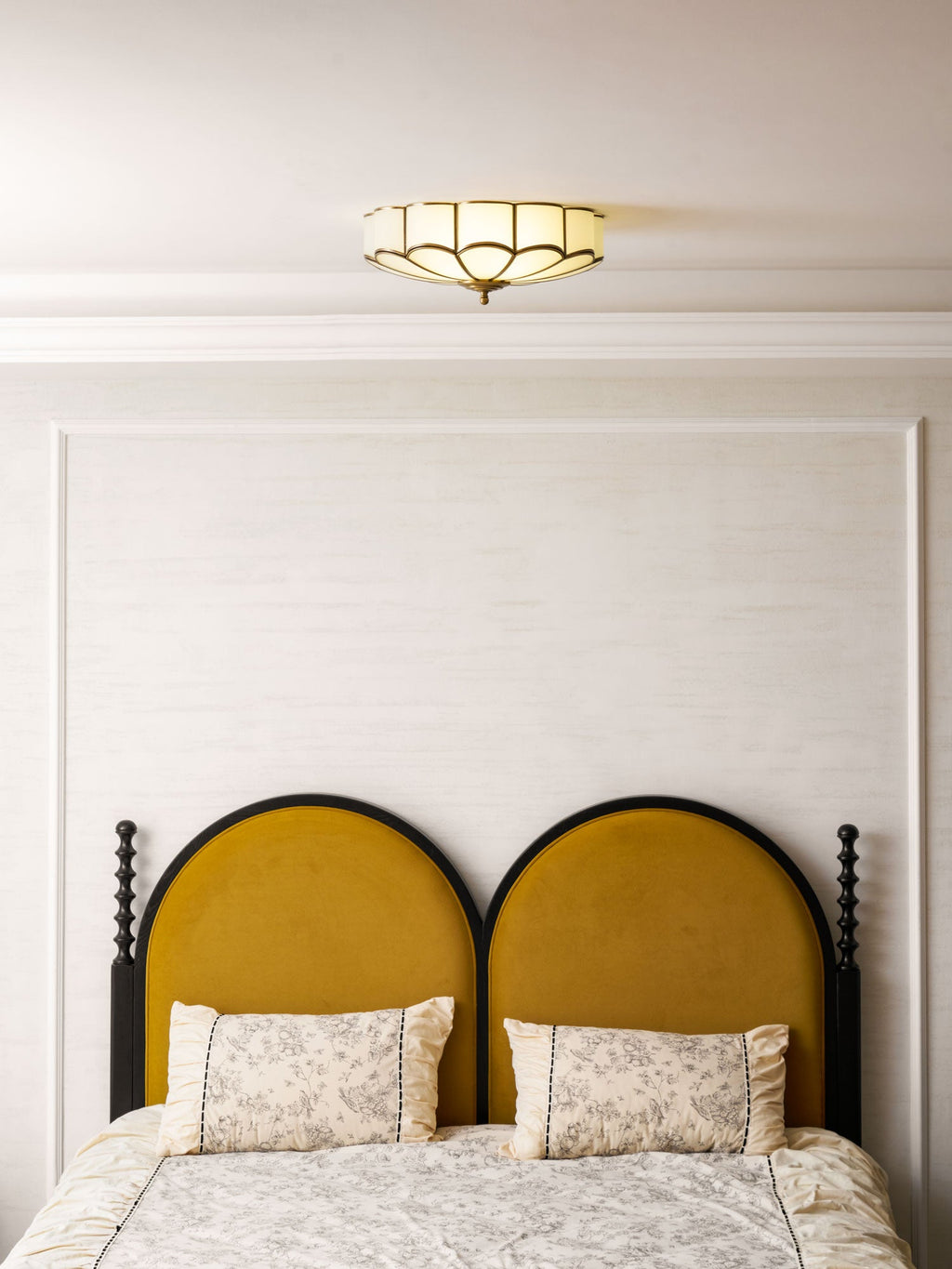 Frosted glass petals and brass frame ceiling light close-up