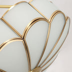 Close view of the frosted-glass petals and brass ribs forming the dome of this Clérachic ceiling light.