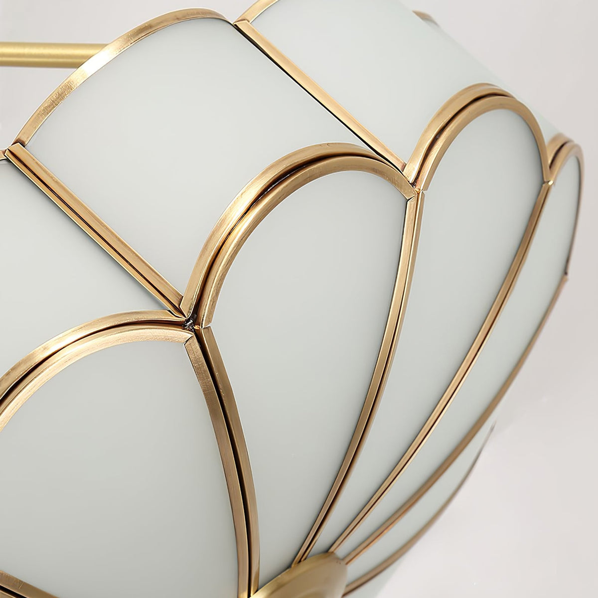 Close view of the frosted-glass petals and brass ribs forming the dome of this Clérachic ceiling light.