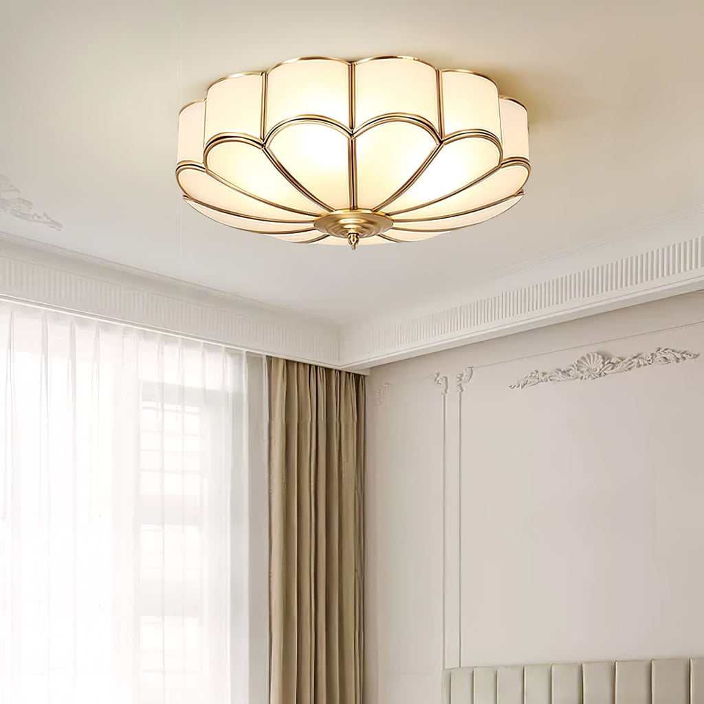 Brass flower ceiling light glowing warmly in a styled room