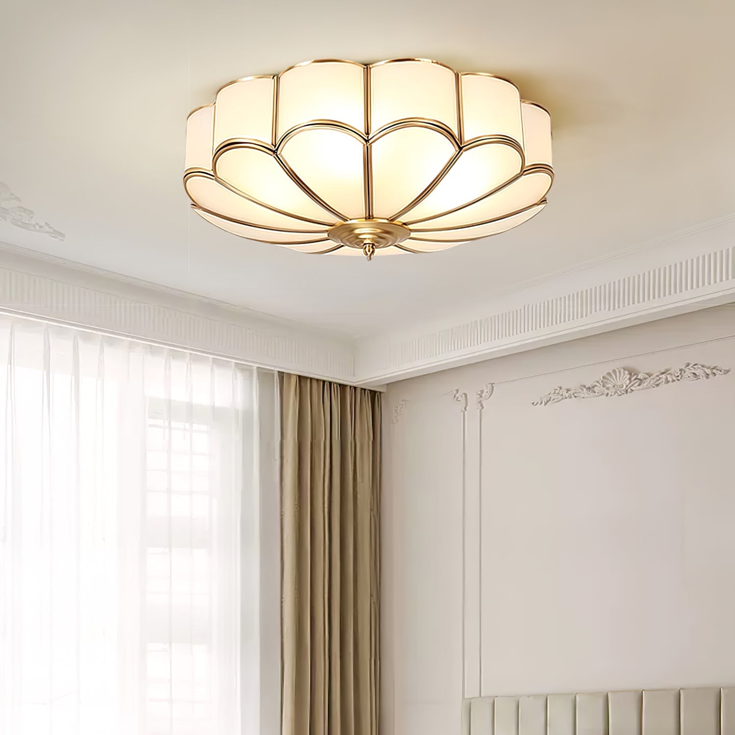 Brass flower ceiling light glowing warmly in a styled room