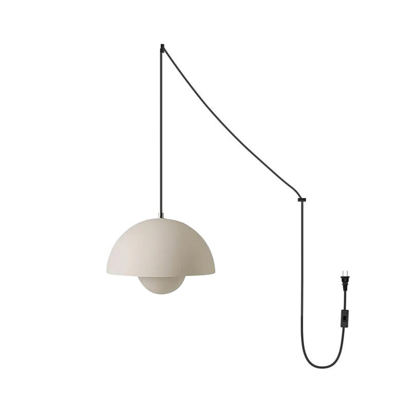Matte sand-beige pendant shade on the black swag cord, shown against a plain white background