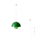 Grass-green pendant lit on the white cord version, colour glowing through the sphere diffuser