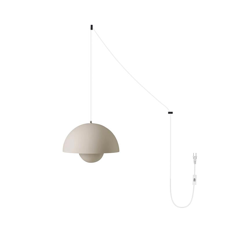 Matte greige pendant shade shown with the white cord option running to a white plug and switch