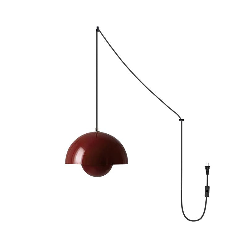 Glossy deep red dome shade of the plug-in pendant, with the small sphere diffuser tucked beneath it