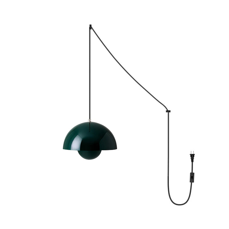Dark green pendant seen straight on, a highlight running down the curve of the glossy dome