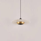 Underside view of a Clérachic disc pendant light, showing the black dome, gold ring and white marble shade.