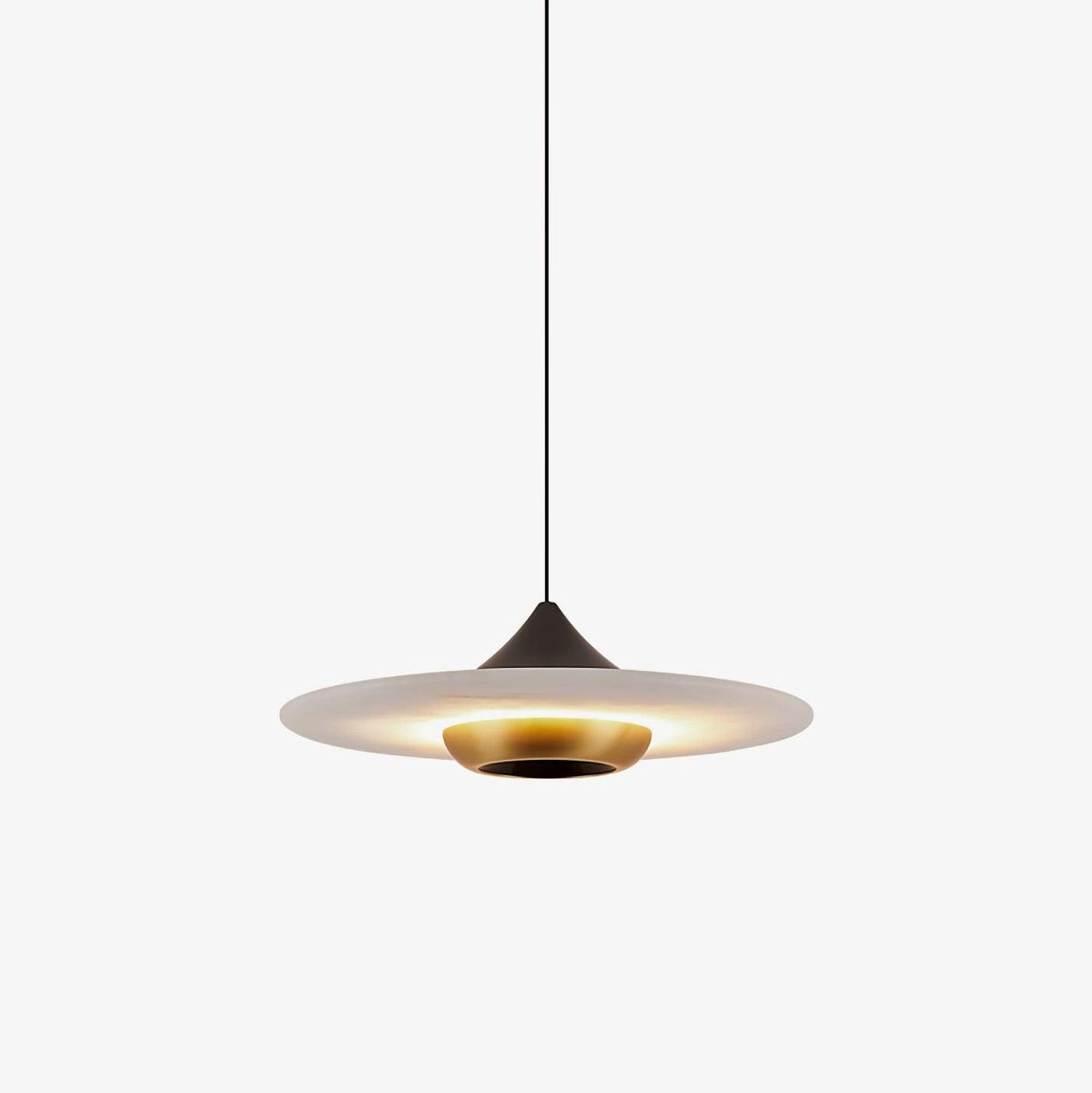 Clérachic pendant light with a wide flat disc shade lit warm underneath, its slim black cord meeting a dark cone fitting and brass ring, shown on white.