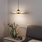 Clérachic white marble pendant light hangs above a nightstand holding a green ceramic vase and a marble trinket box.
