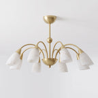 Photographed from the side on a plain backdrop, this Clérachic chandelier's brass frame supports eight cone-shaped alabaster shades.