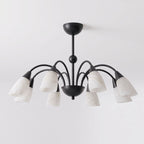 On a white background, the matte black finish of this Clérachic chandelier contrasts with its pale alabaster shades.