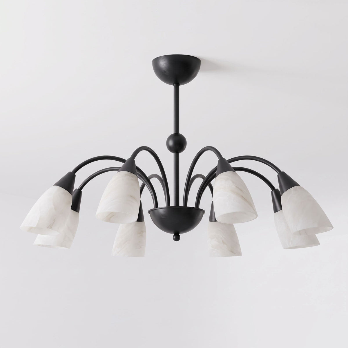 On a white background, the matte black finish of this Clérachic chandelier contrasts with its pale alabaster shades.