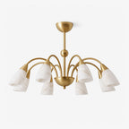 Against a plain white background, the brushed brass finish of this Clérachic chandelier arches into eight downward-facing alabaster shades.