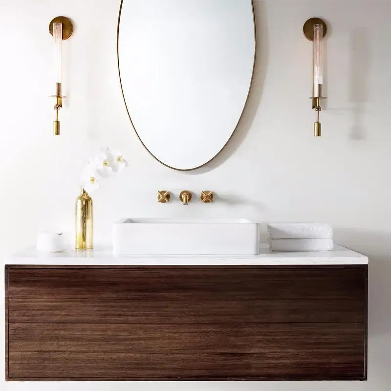Brass wall lamp with ribbed glass cylinder switched on