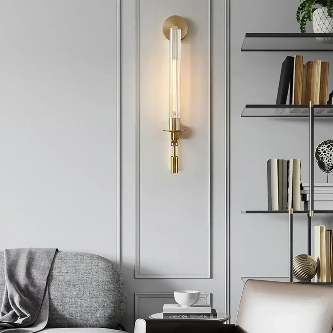 Brass wall sconce with ribbed glass beside neutral decor