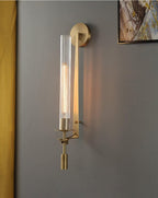 Brass sconces lighting a wall with a soft warm glow